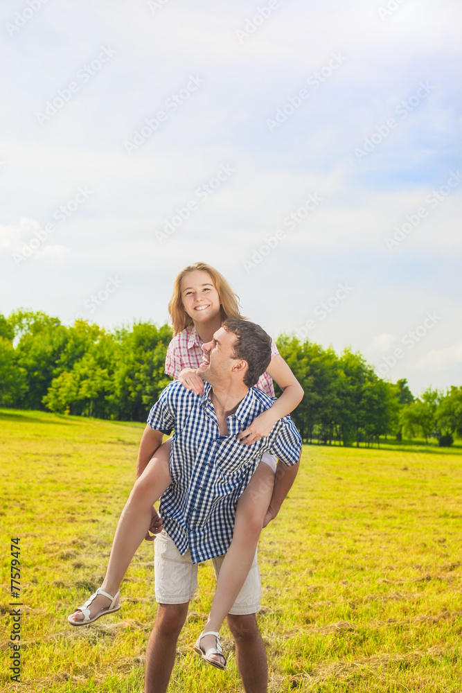 Young Man Giving Woman Piggyback Outdoors, Stock image