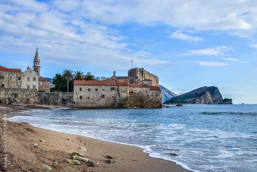 Montenegro. Budva beach near old town wall and fortress in winte