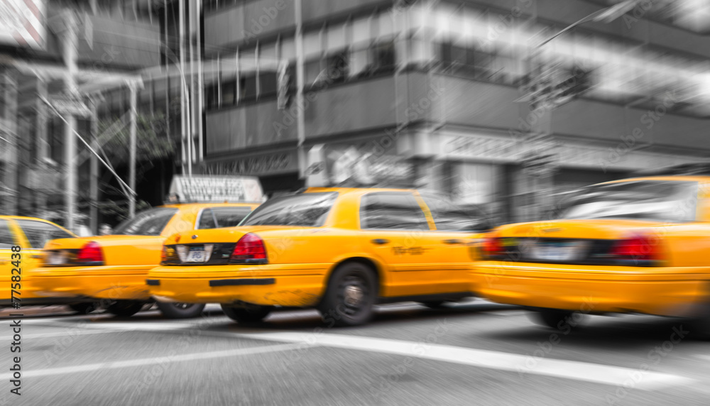 Zoomed and blurred view of New York yellow cabs isolated on blac