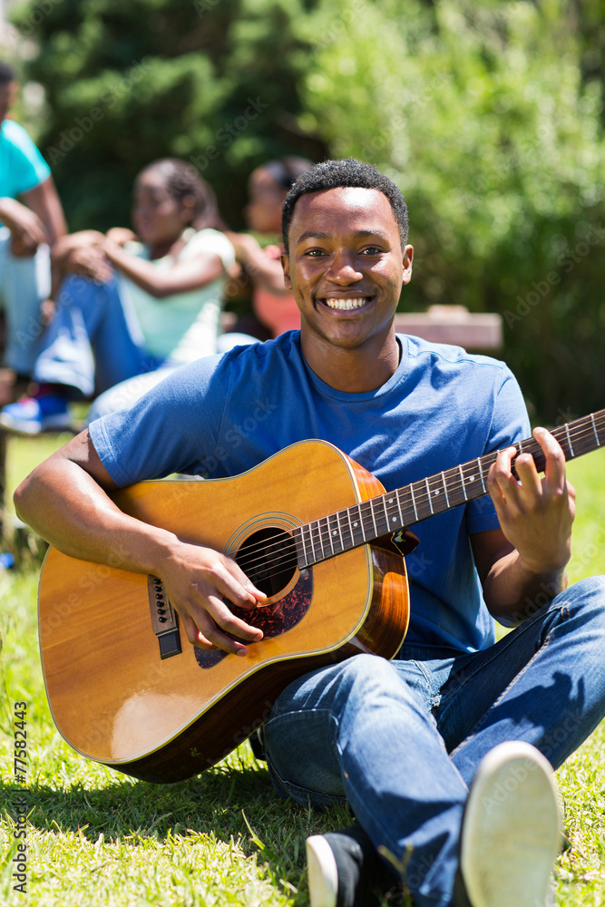 african college student playing guitar