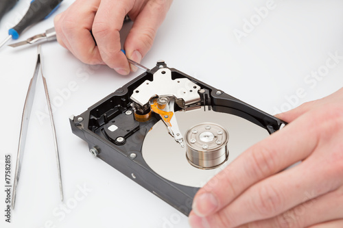 Hard disk without cover and tweezers