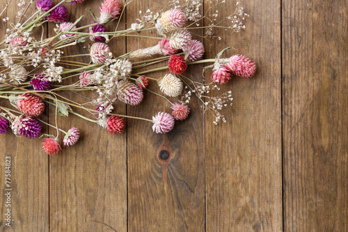 Dried flowers on rustic wooden planks background