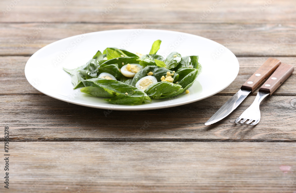 Salad with quail egg and basil in plate Salad with quail egg and basil in plate