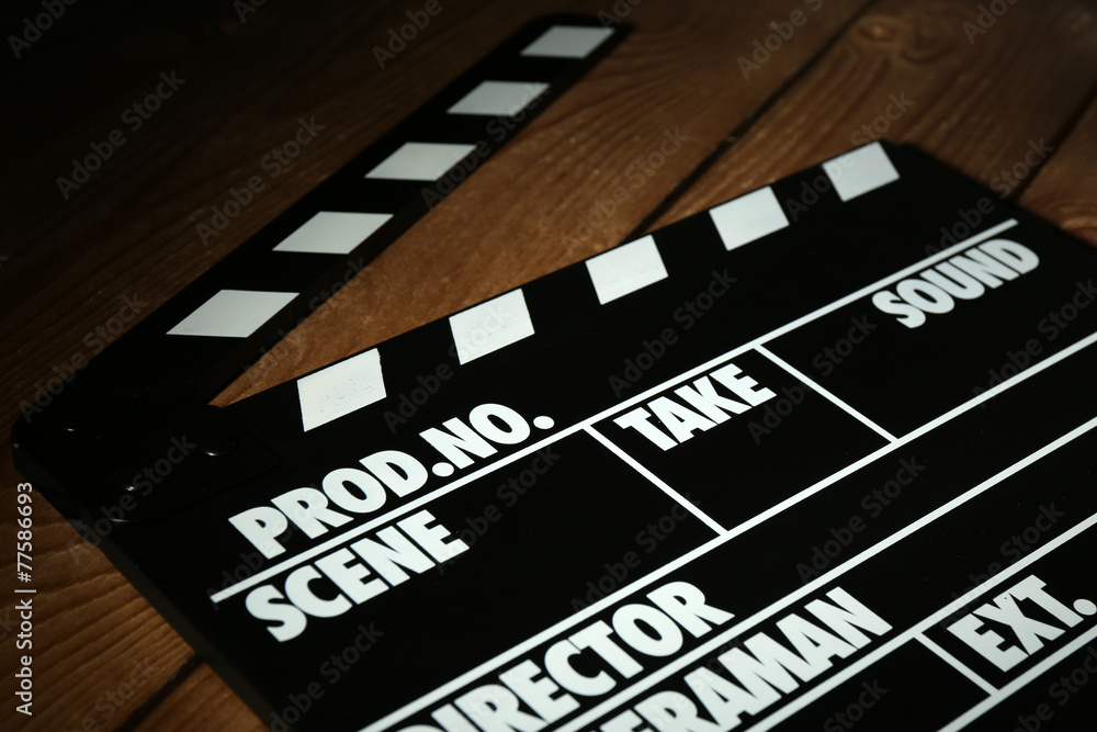 Fototapeta premium Movie clapper on wooden background