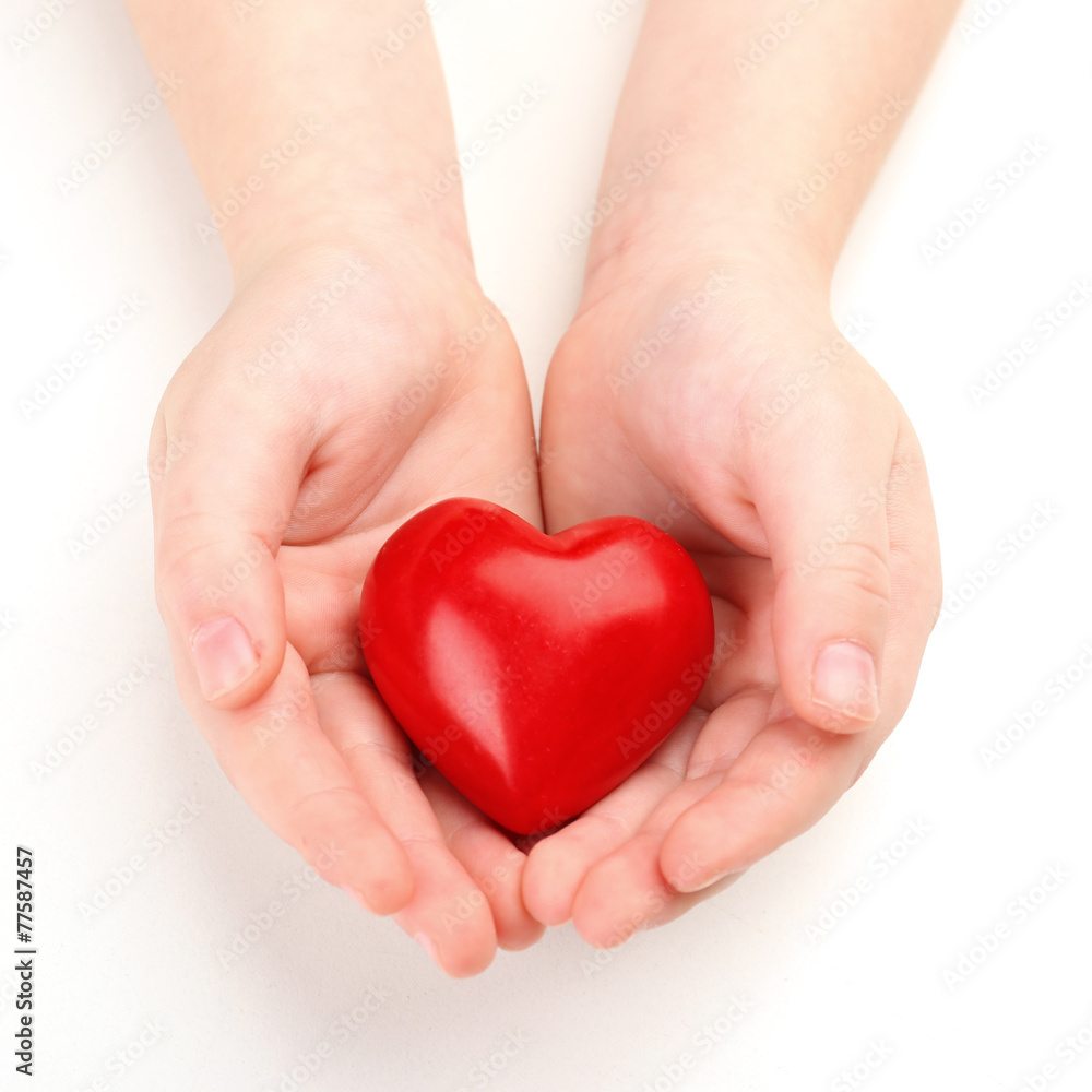 Heart in child hands isolated on white