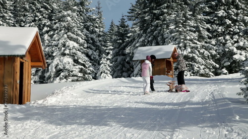 a family with children while enjoying in the idyllic winter time soroundings photo