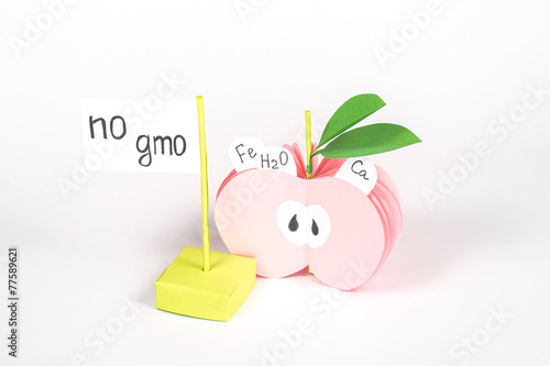 half paper apple with vitamin and card with word 