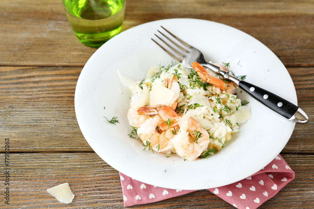 Risotto with shrimp and dill on white plate Risotto with shrimp and dill on white plate
