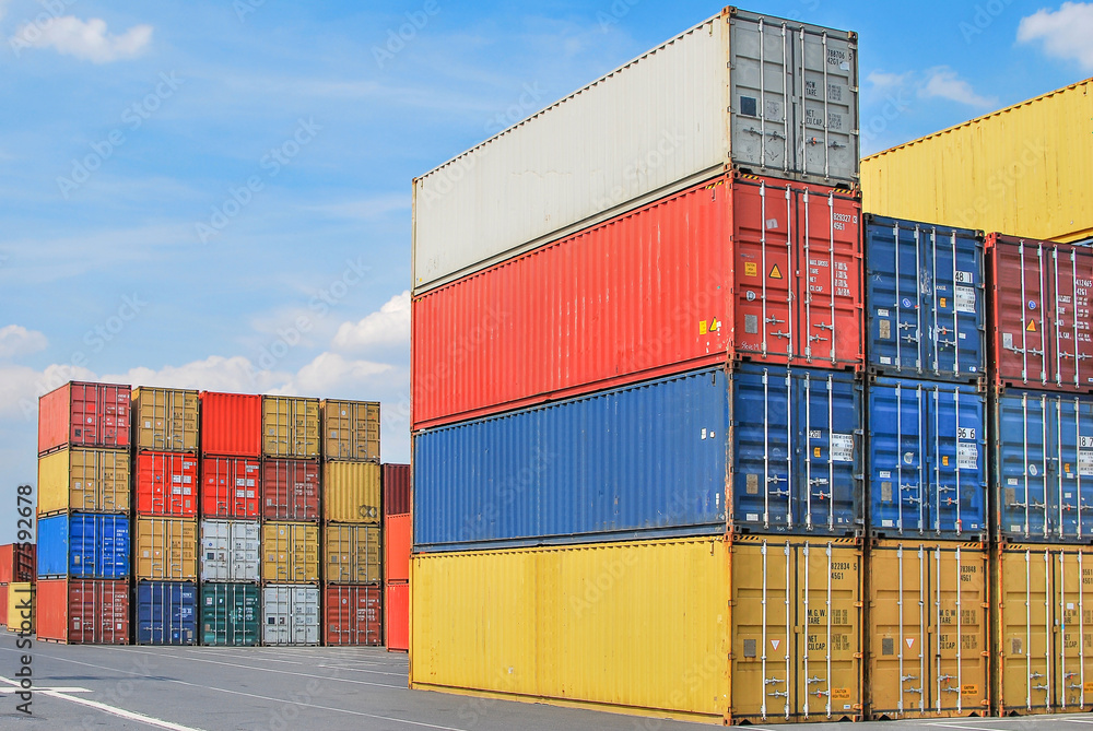 Stacked cargo containers in storage area of freight sea port ter Stacked cargo containers in storage area of freight sea port ter