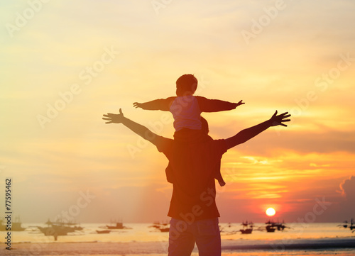 father and son having fun on sunset