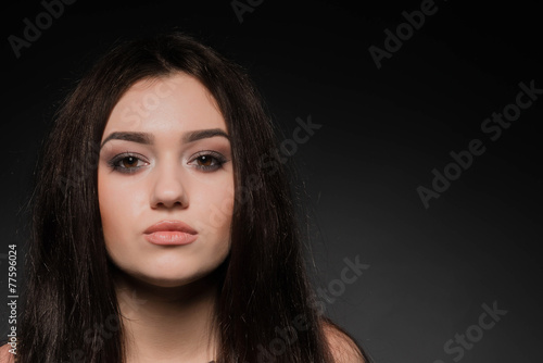 Beautiful brunette girl on dark background