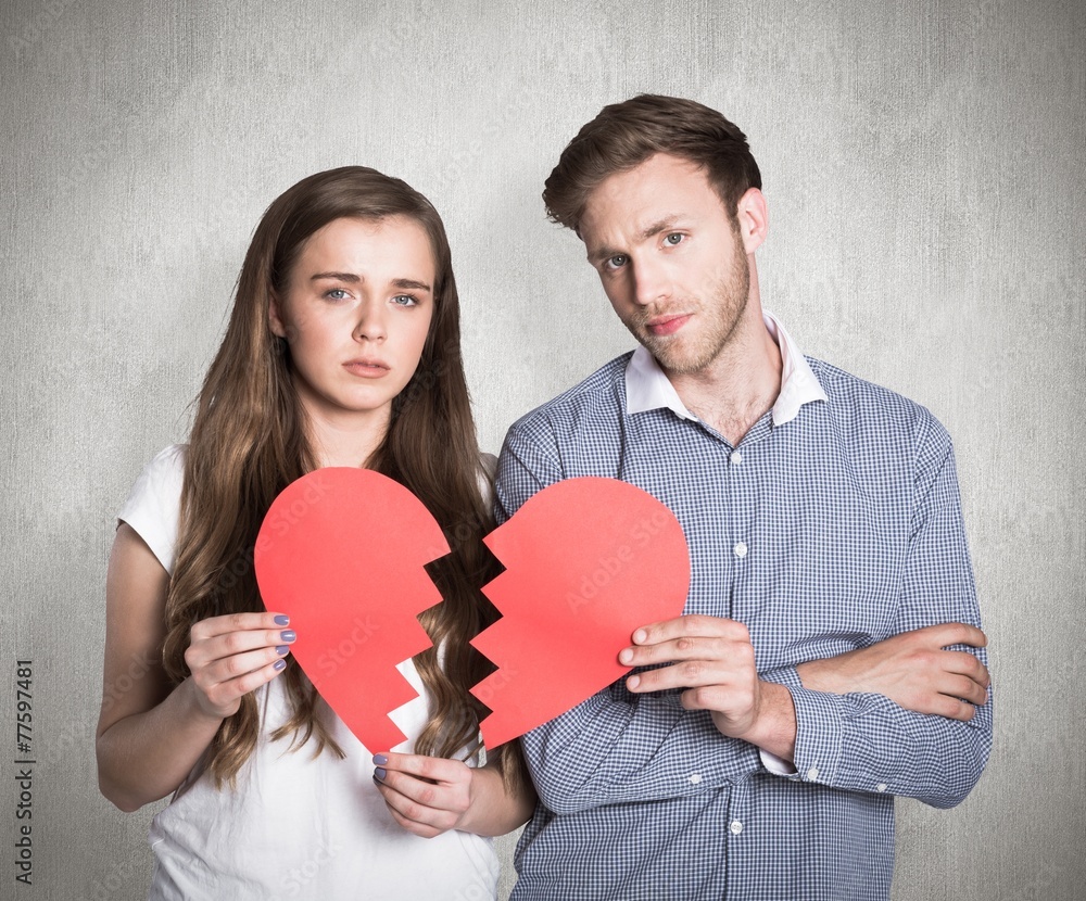 Composite image of couple holding broken heart Composite image of couple holding broken heart