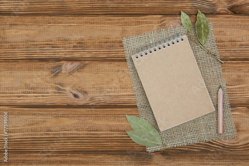 Blank notepad for copy space and herbs on wooden table!