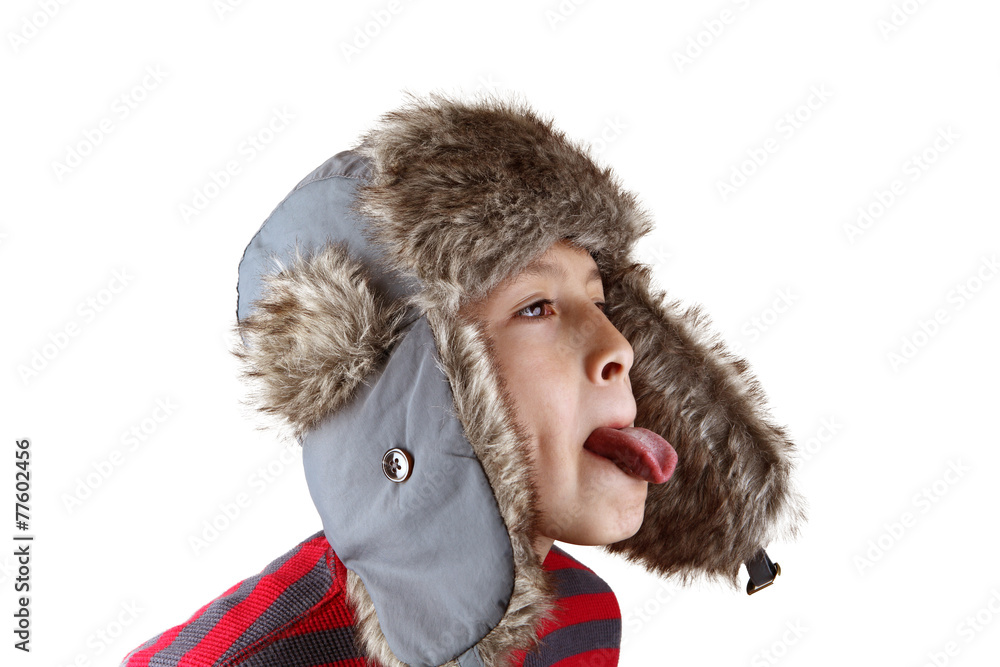 Boy in furry hat pulling funny faces on white background Boy in furry hat pulling funny faces on white background