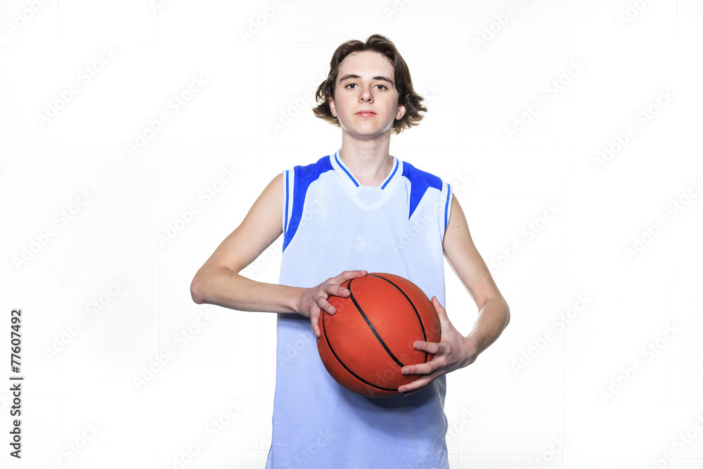 A teenager basketball player over a white background A teenager basketball player over a white background