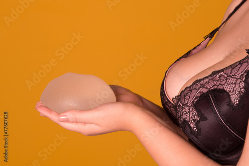 Plakat w ramie Silicone implants on hand and natural brest