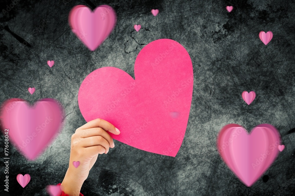 Fototapeta premium Composite image of couple holding a heart
