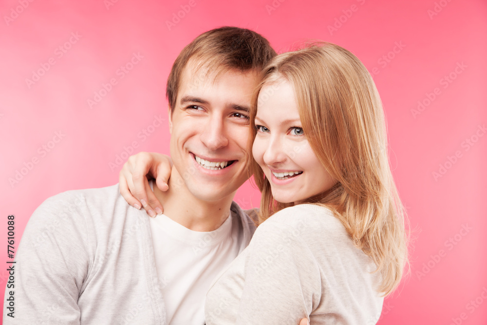 smiling couple hugging, looking aside smiling couple hugging, looking aside