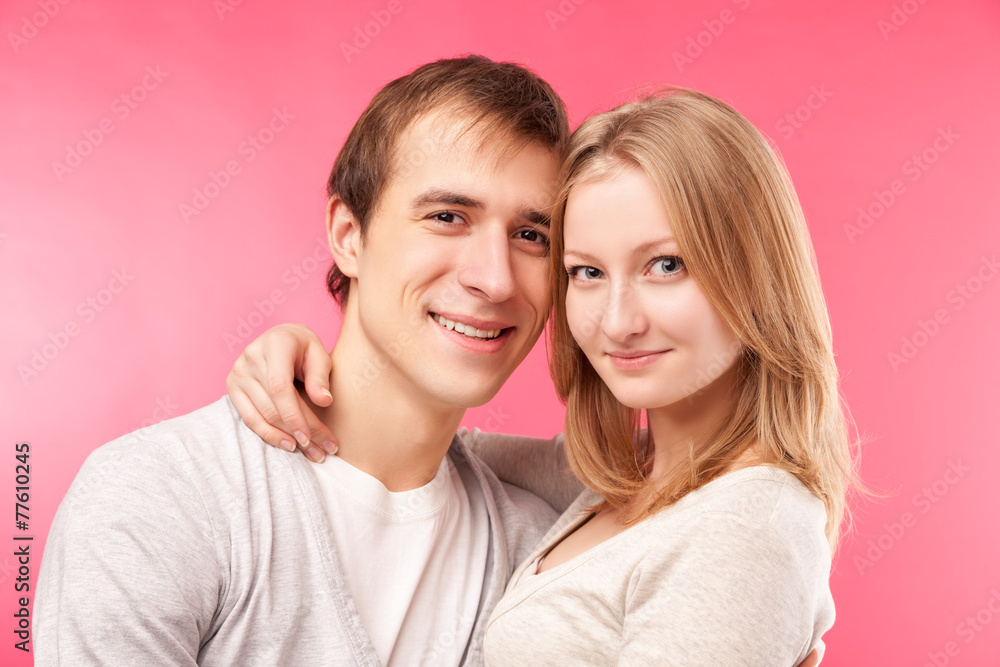 smiling couple hugging, looking in the camera smiling couple hugging, looking in the camera