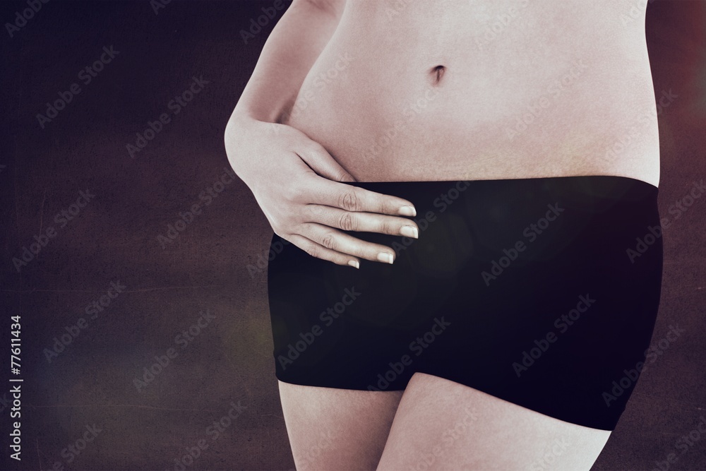 Fototapeta premium Closeup mid section of a fit woman in black