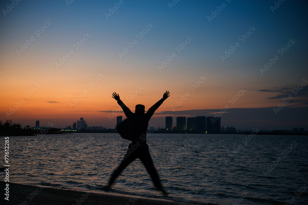 freedom and creativity, man jumping on the beach