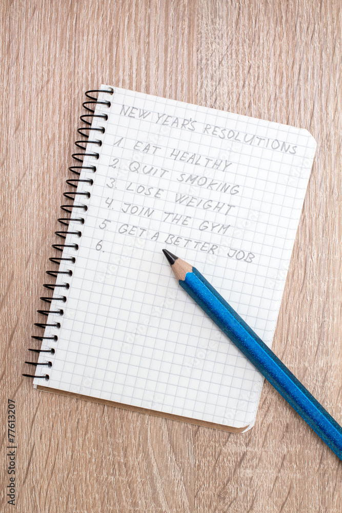 Blue pencil and notepad with resolutions Blue pencil and notepad with resolutions