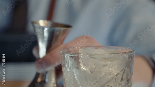 The bartender cooks cocktail