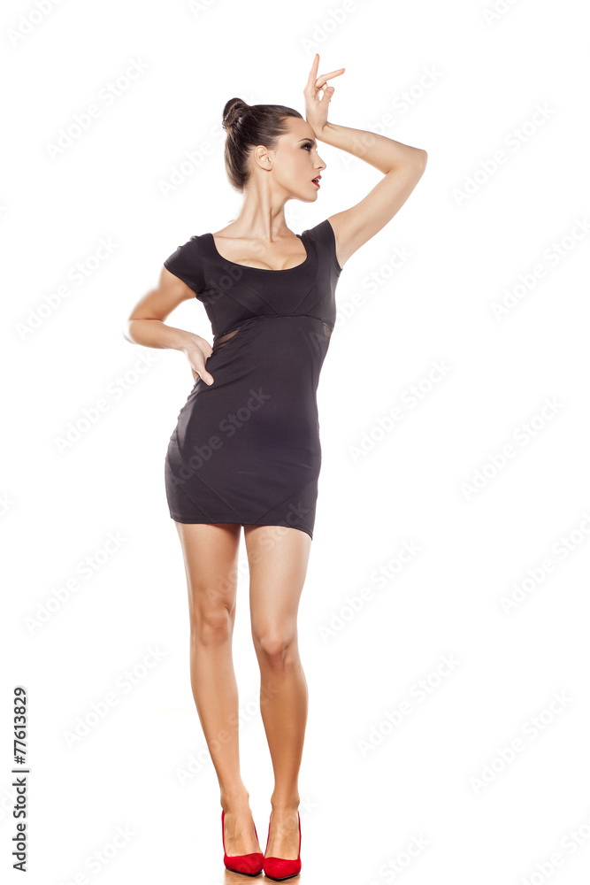 Pretty young woman with black short dress, and bun Pretty young woman with black short dress, and bun
