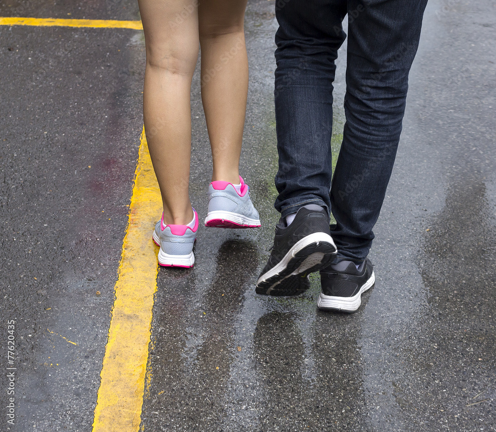 Man and woman walk together.Crop only leg and foot.