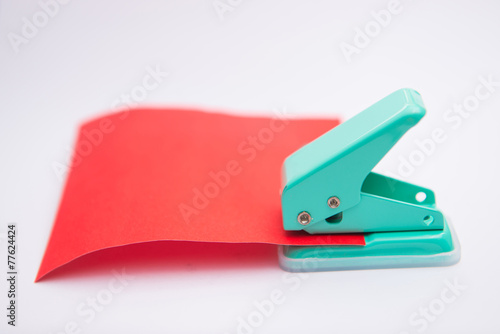 green paper punches with red paper