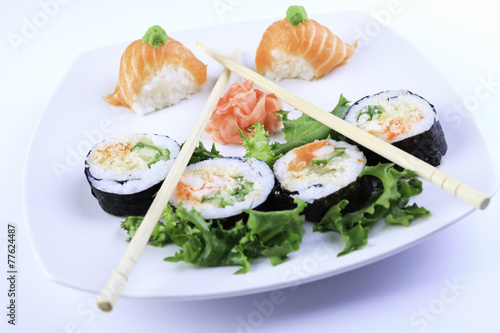 Sushi maki set and sakura branch. Isolated on white background