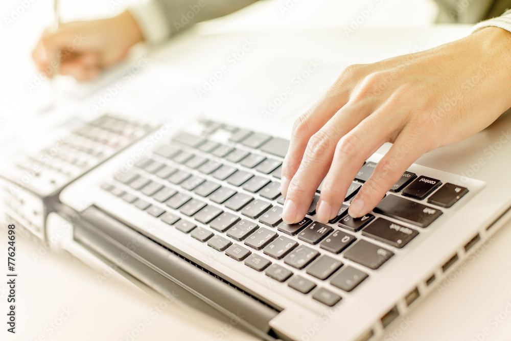 Closeup of businessman hands typing on laptop computer Closeup of businessman hands typing on laptop computer