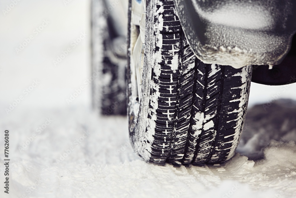 Detail of the tire on winter road - obrazy, fototapety, plakaty 