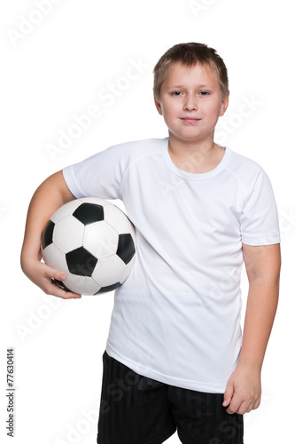 Confident young boy with soccer ball © SergiyN