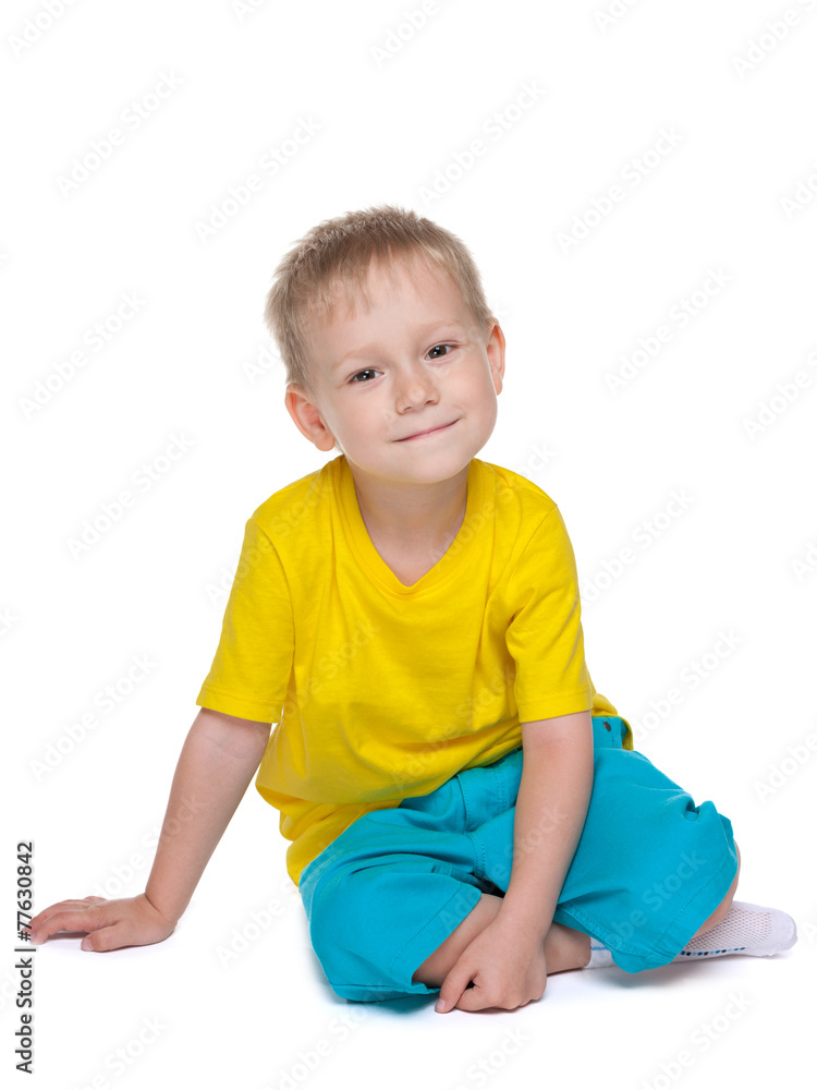 Cute little boy sits