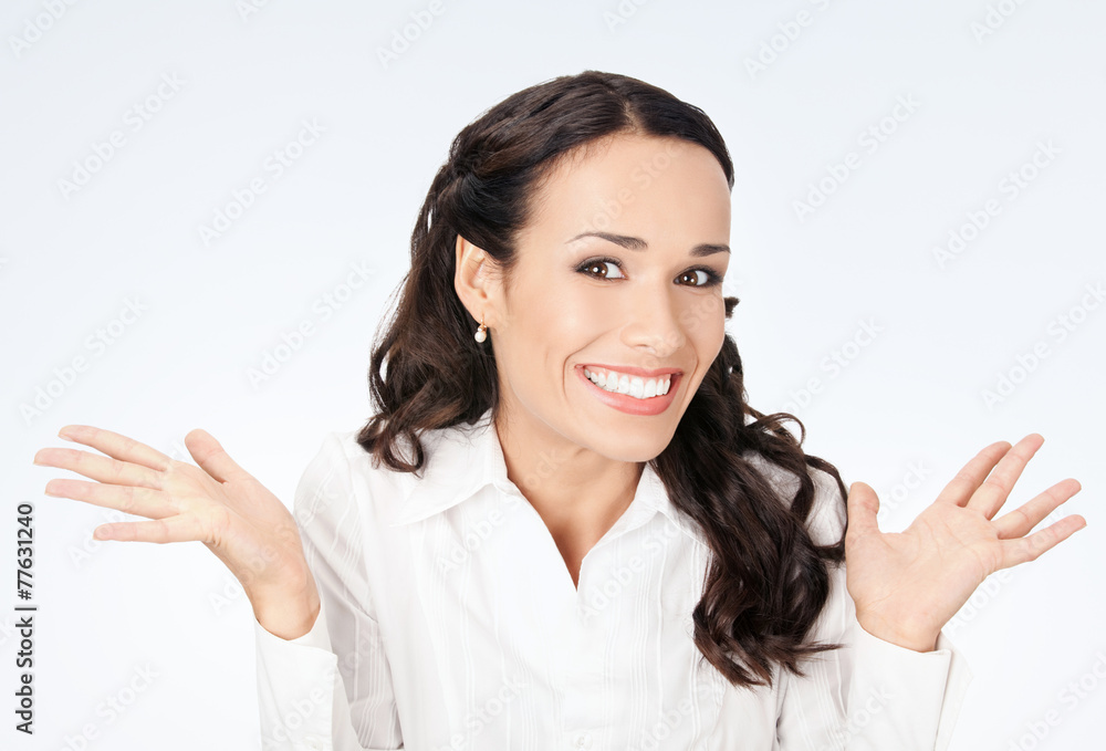 Happy gesturing smiling business woman, on grey Happy gesturing smiling business woman, on grey