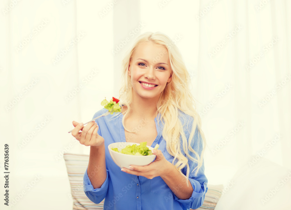 smiling young woman with green salad at home smiling young woman with green salad at home