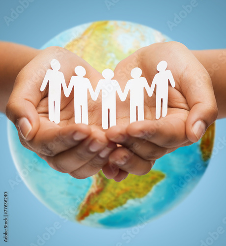 close up of human hands with earth globe