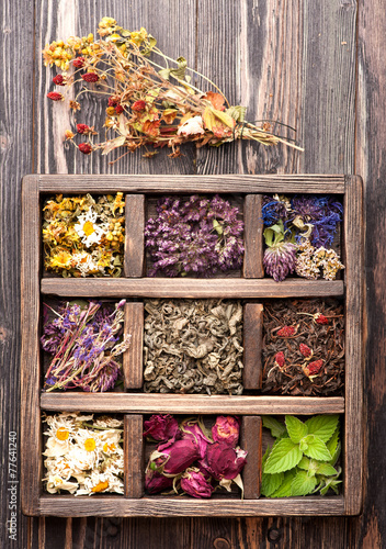 dried medicinal  herbs and flowers  in a wooden box
