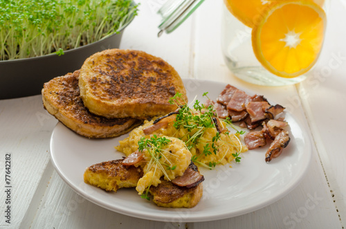 Scrambled eggs with French toast topped with watercress photo