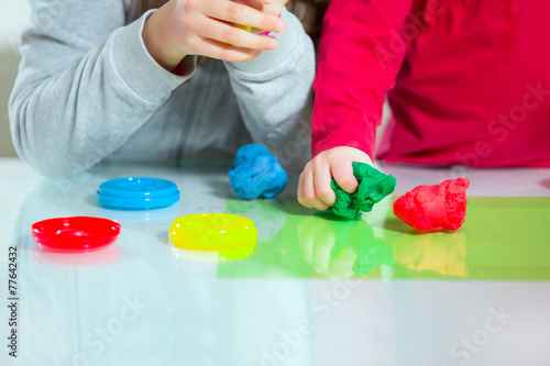 Little children working with plasticine
