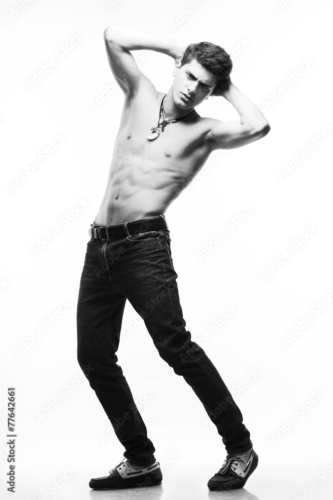 Male beauty & jeans concept. Handsome male model posing Male beauty & jeans concept. Handsome male model posing