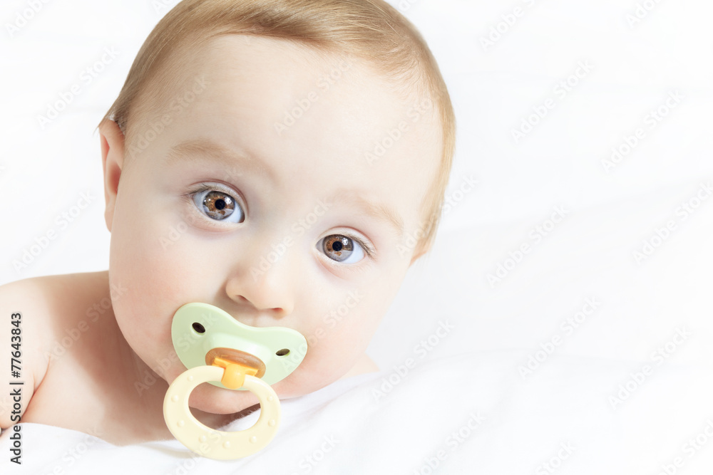 Baby portrait on the bed with white background Baby portrait on the bed with white background