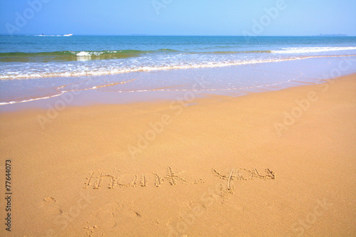 Beautiful beach with sand, blue waves and sky