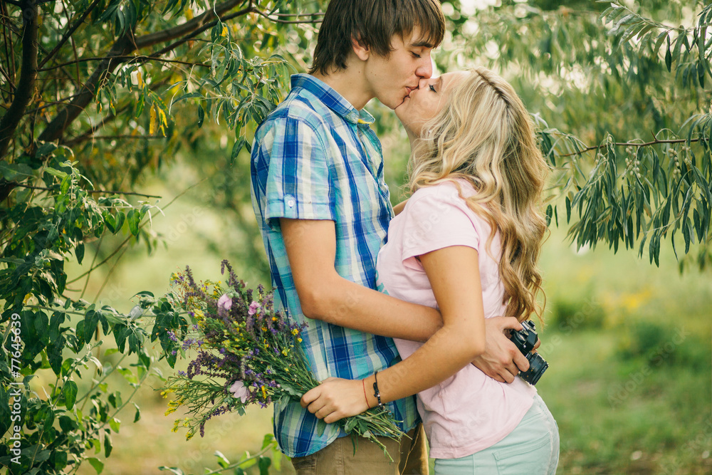 teenage couple kissing and embracing