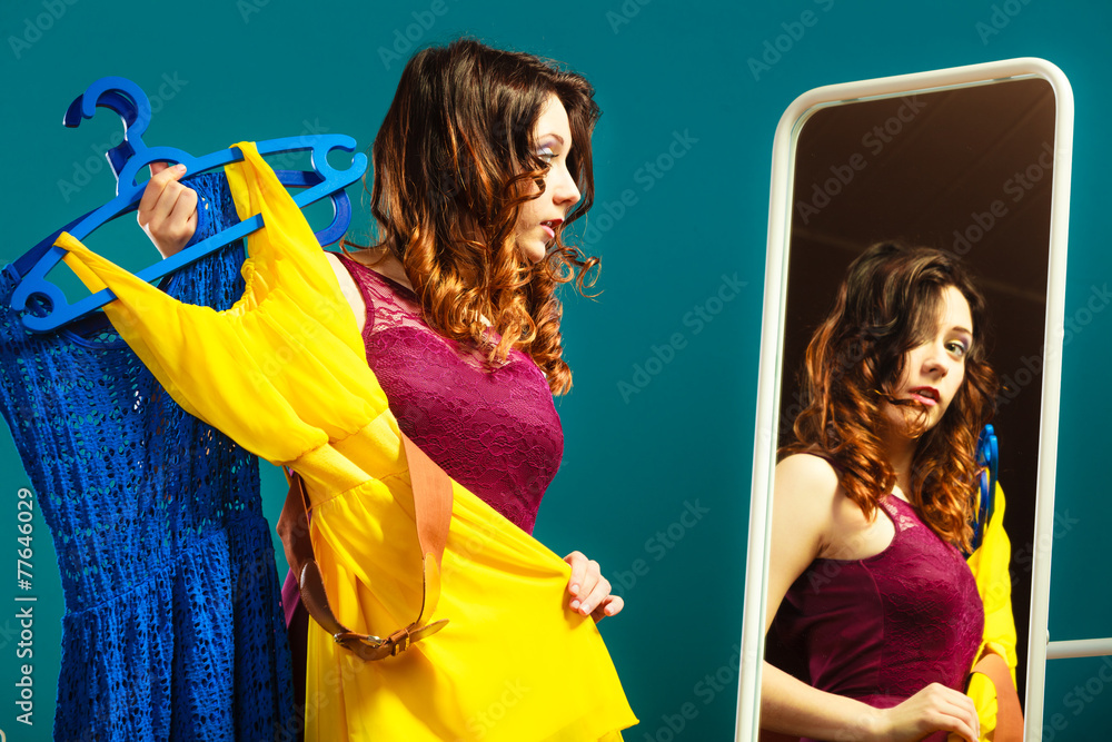 Naklejka premium Woman trying dress shopping for clothing.
