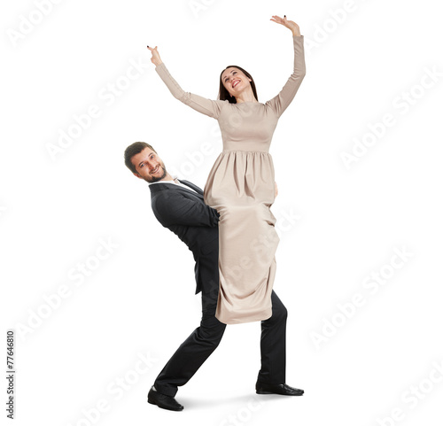 smiley man holding young happy woman