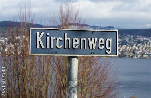 Kirchenweg - Strassenschild mit See photo