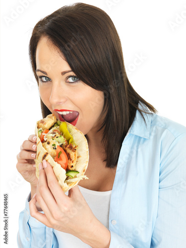 Young Woman Eating Chicken Kebab with Salad