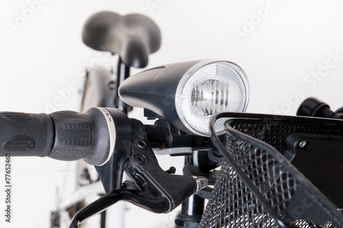 Front bicycle lamp on the steering whee photo